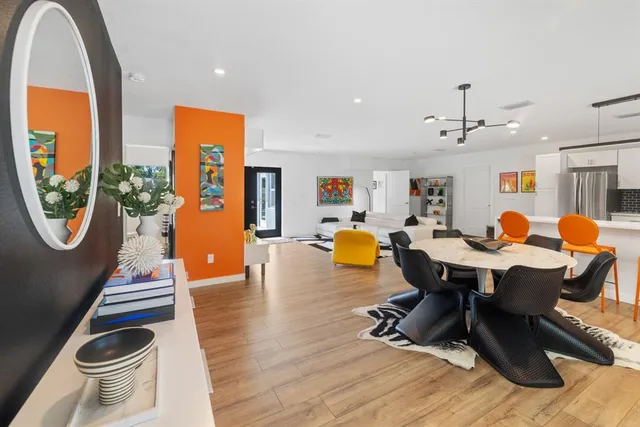 a living room with dining room and wooden floor