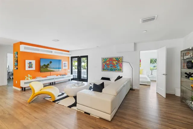 a living room with furniture and a table with wooden floor
