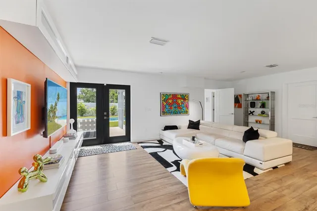 a living room with furniture fireplace and large window