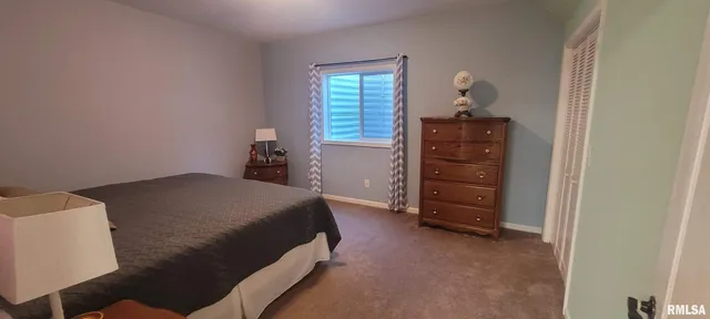 a bedroom with a bed and a dresser