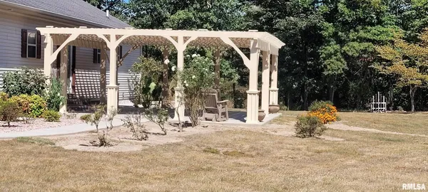 a view of a house with backyard and sitting area
