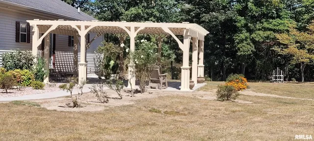 a view of a house with backyard and sitting area