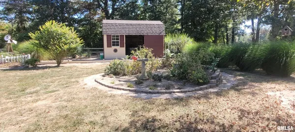 a view of swimming pool with outdoor seating and house in the background