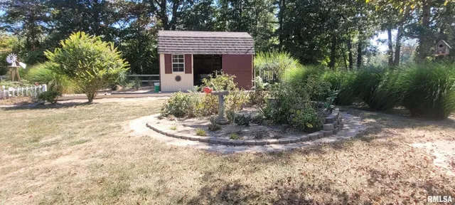 a view of swimming pool with outdoor seating and house in the background