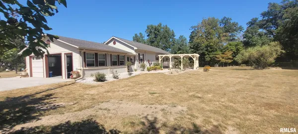 a view of a wooden house with a backyard