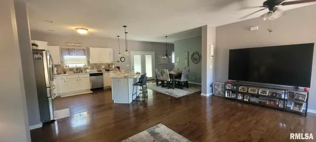 a view of a living room kitchen and a wooden floor
