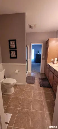 a bathroom with a toilet and a mirror