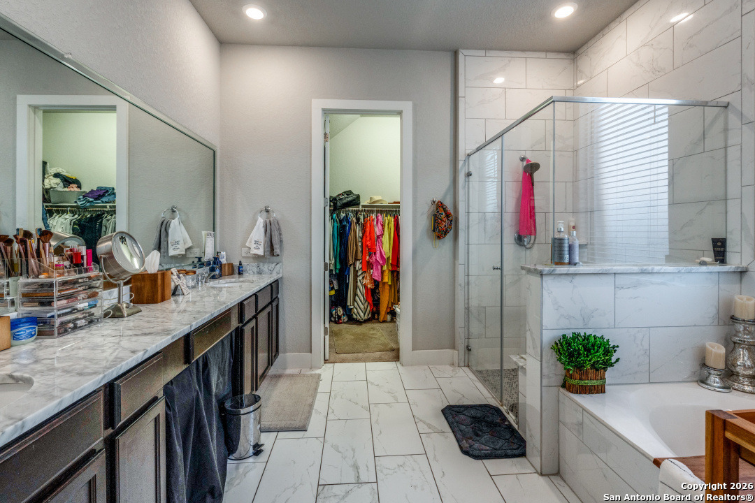 1712 Delafield Road San Antonio, TX 78253 - Photo 14 of 25 a bathroom with a granite countertop sink a mirror and shower