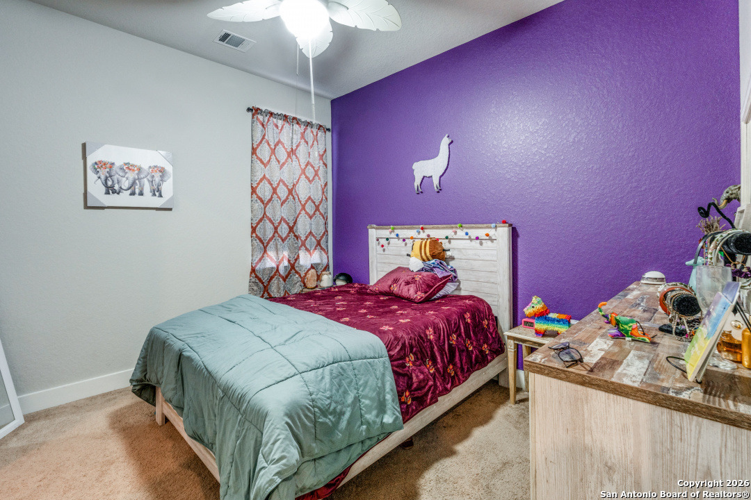 1712 Delafield Road San Antonio, TX 78253 - Photo 21 of 25 a bedroom with a bed and a chandelier