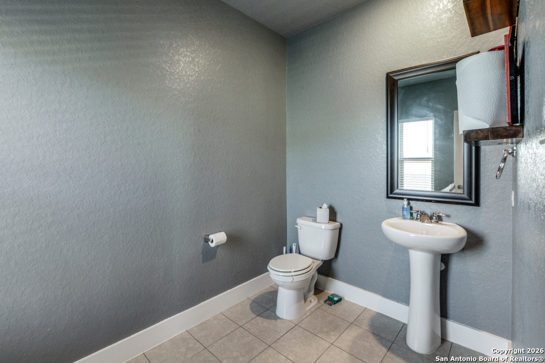1712 Delafield Road San Antonio, TX 78253 - Photo 23 of 25 a bathroom with a toilet sink and mirror