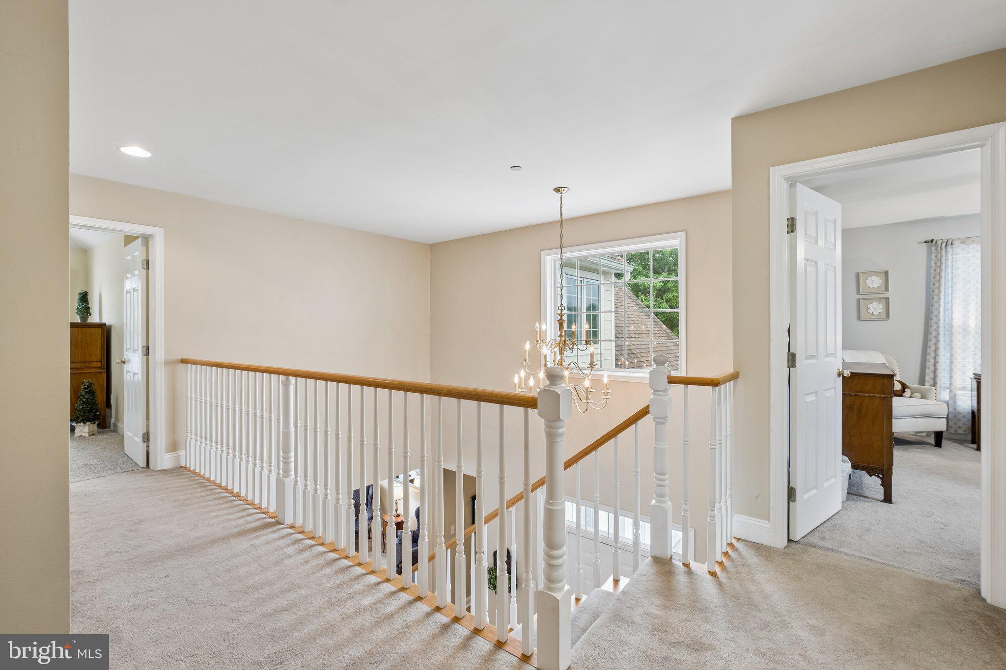 305 Langford Road Broomall, PA 19008 - Photo 34 of 83 a view of a hallway with wooden floor and windows