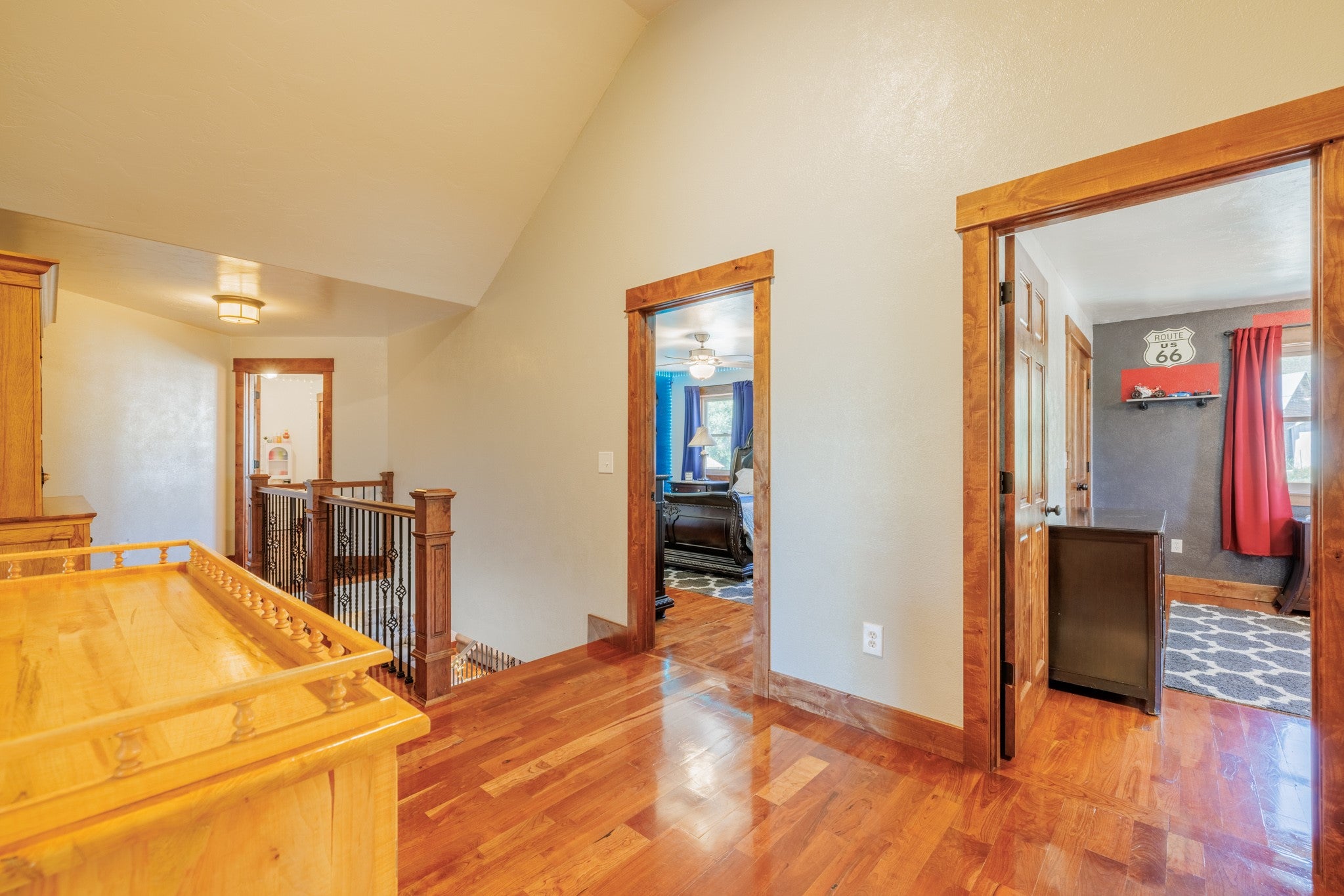 58 Gilman Road Garrison, MT 59731 - Photo 70 of 91 Hallway featuring an upstairs landing, wood finished floors, plenty of natural light, and high vaulted ceiling