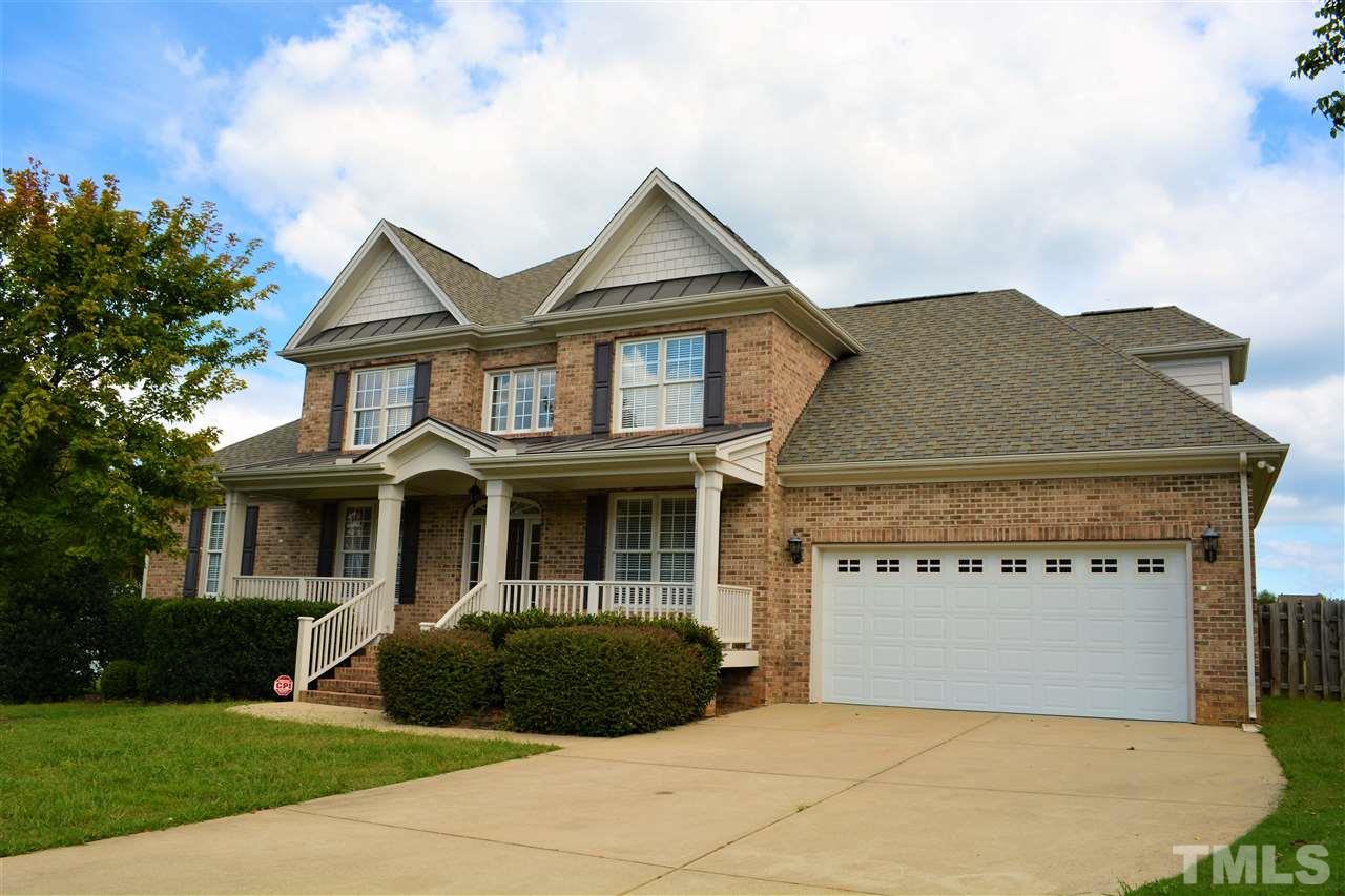 4740 Sandy Bay Circle Raleigh, NC 27603 - Photo 1 of 24 a front view of a house with a garden and garage