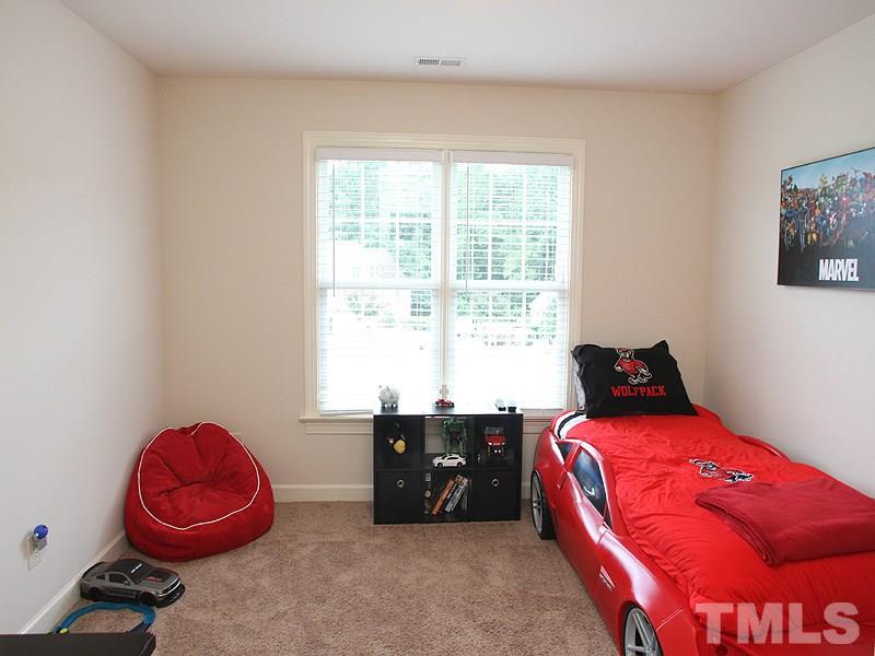 4740 Sandy Bay Circle Raleigh, NC 27603 - Photo 18 of 24 a bedroom with a bed and a window