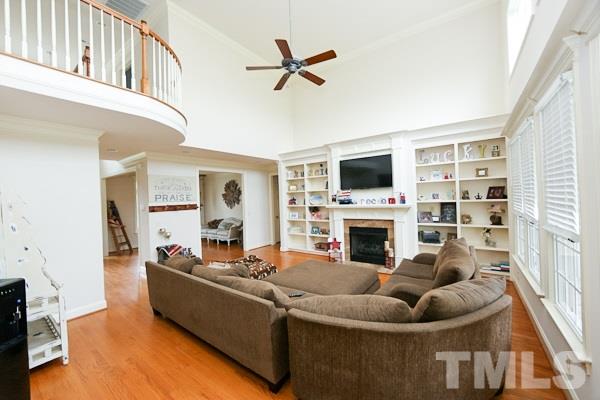 4740 Sandy Bay Circle Raleigh, NC 27603 - Photo 5 of 24 a living room with furniture a fireplace and a flat screen tv