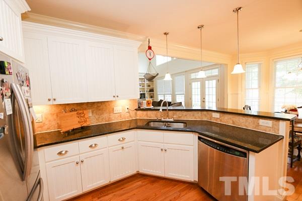 4740 Sandy Bay Circle Raleigh, NC 27603 - Photo 9 of 24 a kitchen with granite countertop a sink stainless steel appliances and cabinets