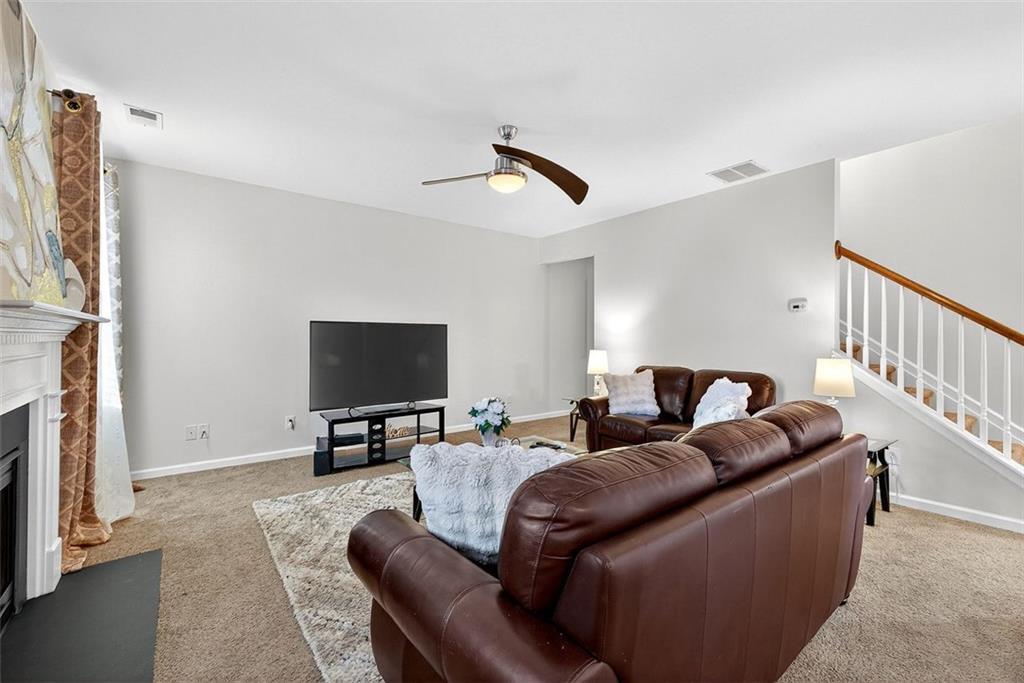 2517 Kolb Manor Circle Southwest Marietta, GA 30008 - Photo 11 of 33 a living room with furniture and a flat screen tv