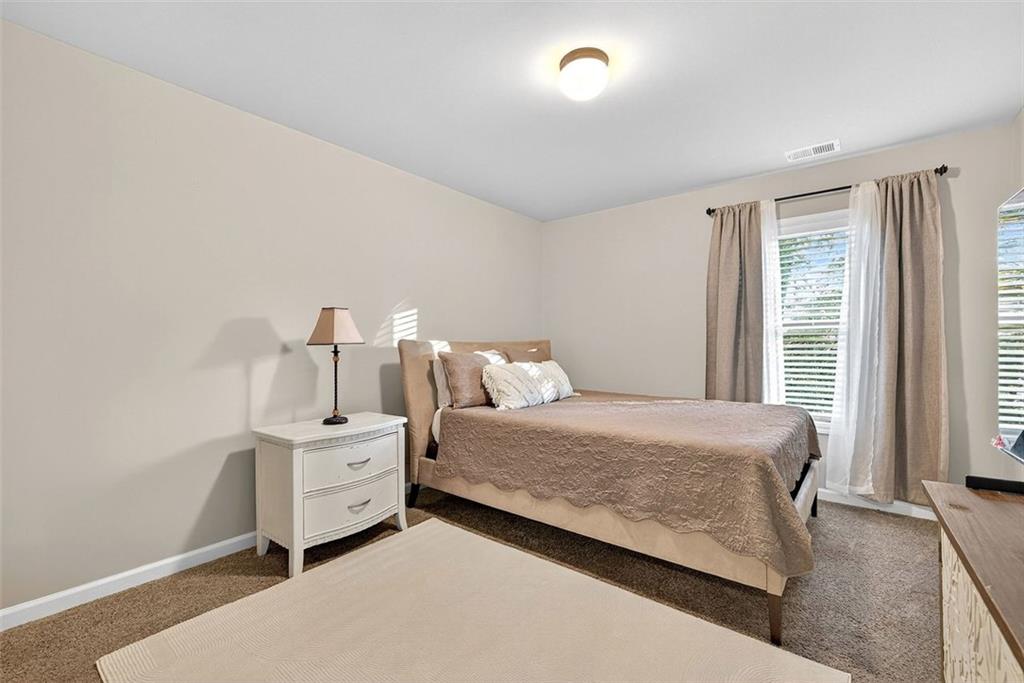 2517 Kolb Manor Circle Southwest Marietta, GA 30008 - Photo 14 of 33 a bedroom with a bed and a window