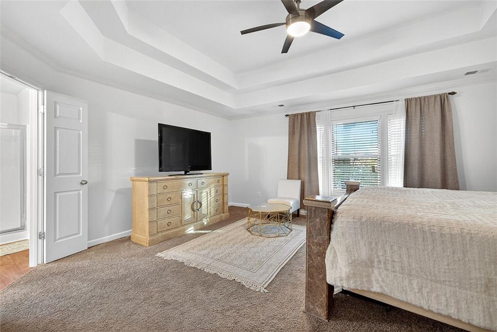 2517 Kolb Manor Circle Southwest Marietta, GA 30008 - Photo 16 of 33 a bedroom with a bed and a flat screen tv on the dresser