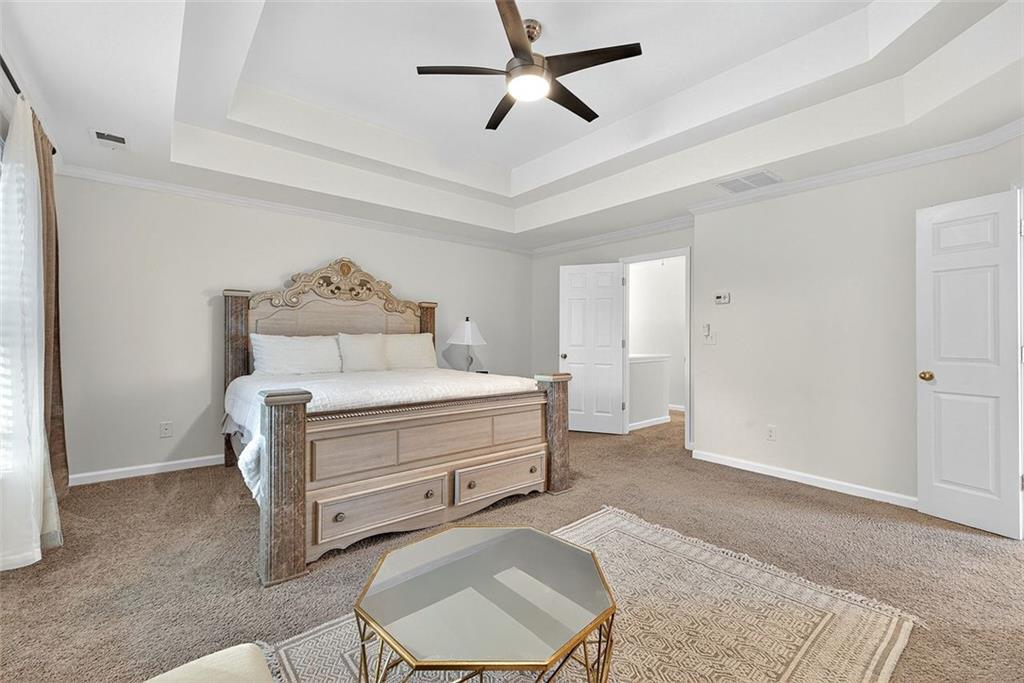 2517 Kolb Manor Circle Southwest Marietta, GA 30008 - Photo 17 of 33 a room with a bed and a chandelier