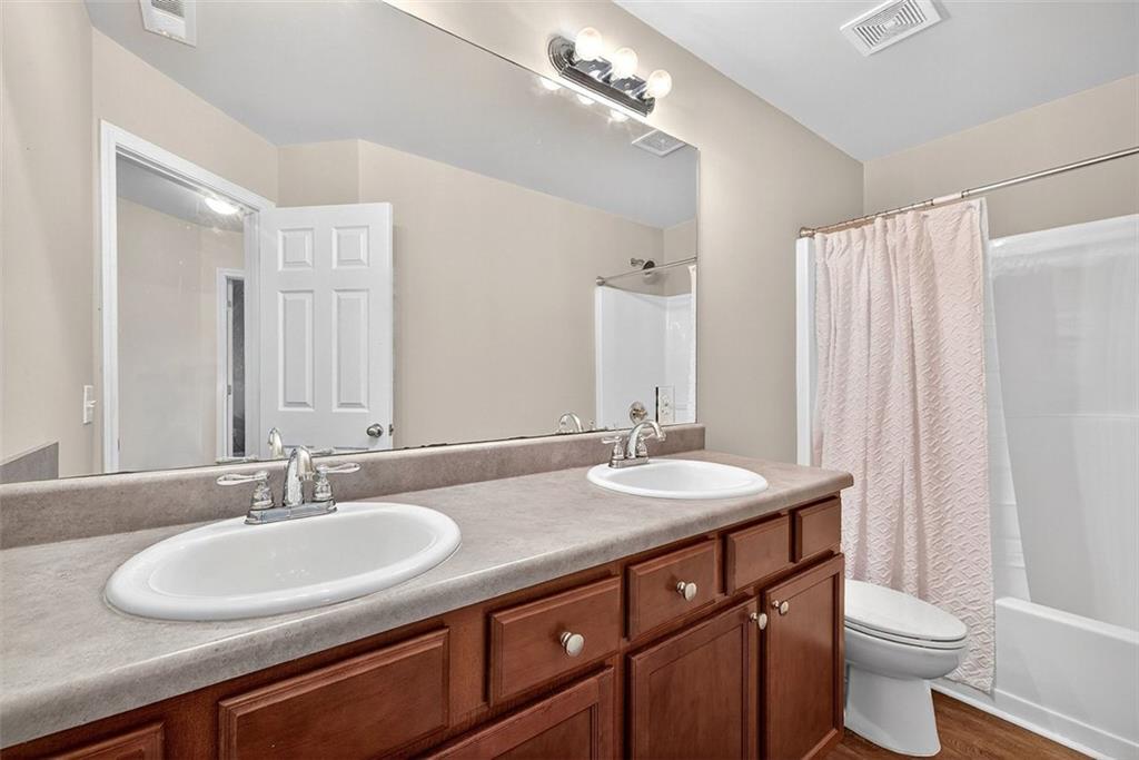 2517 Kolb Manor Circle Southwest Marietta, GA 30008 - Photo 21 of 33 a bathroom with a double vanity sink and a mirror