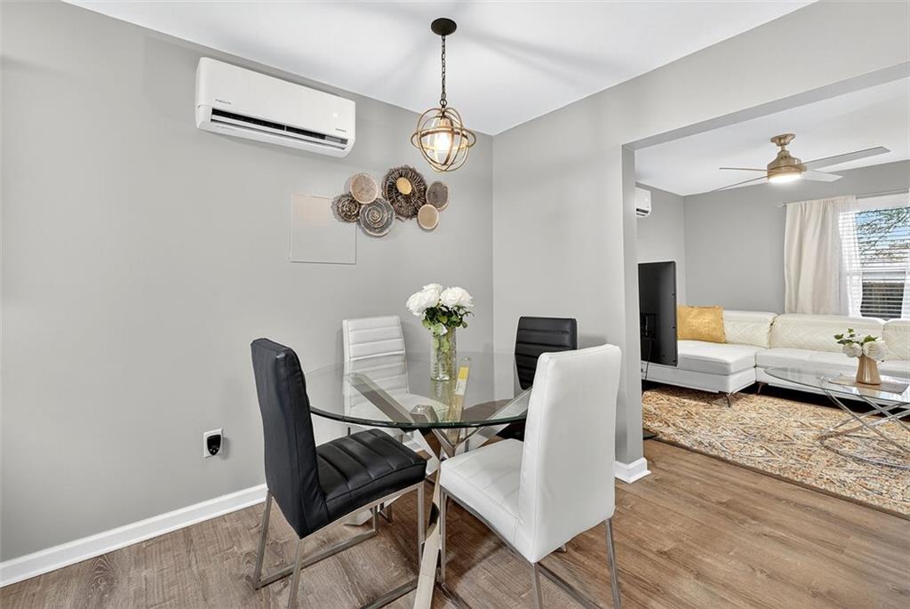 2517 Kolb Manor Circle Southwest Marietta, GA 30008 - Photo 25 of 33 a dining room with furniture a chandelier and wooden floor