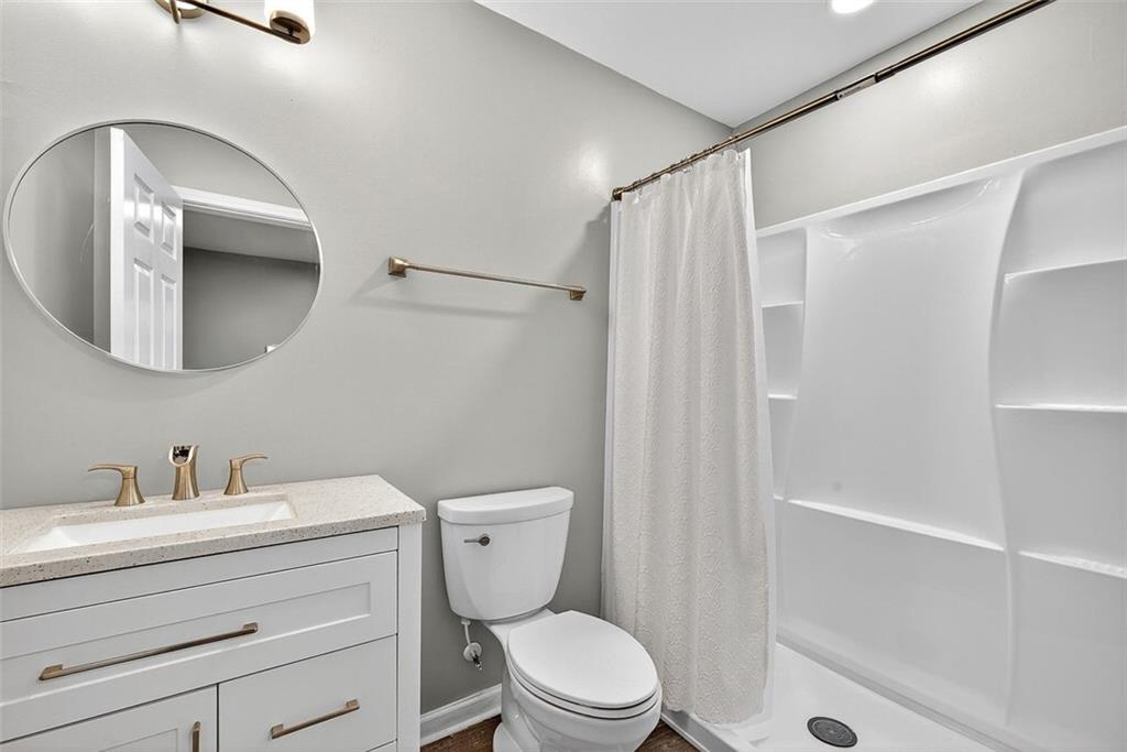 2517 Kolb Manor Circle Southwest Marietta, GA 30008 - Photo 27 of 33 a bathroom with a sink a mirror a toilet and shower
