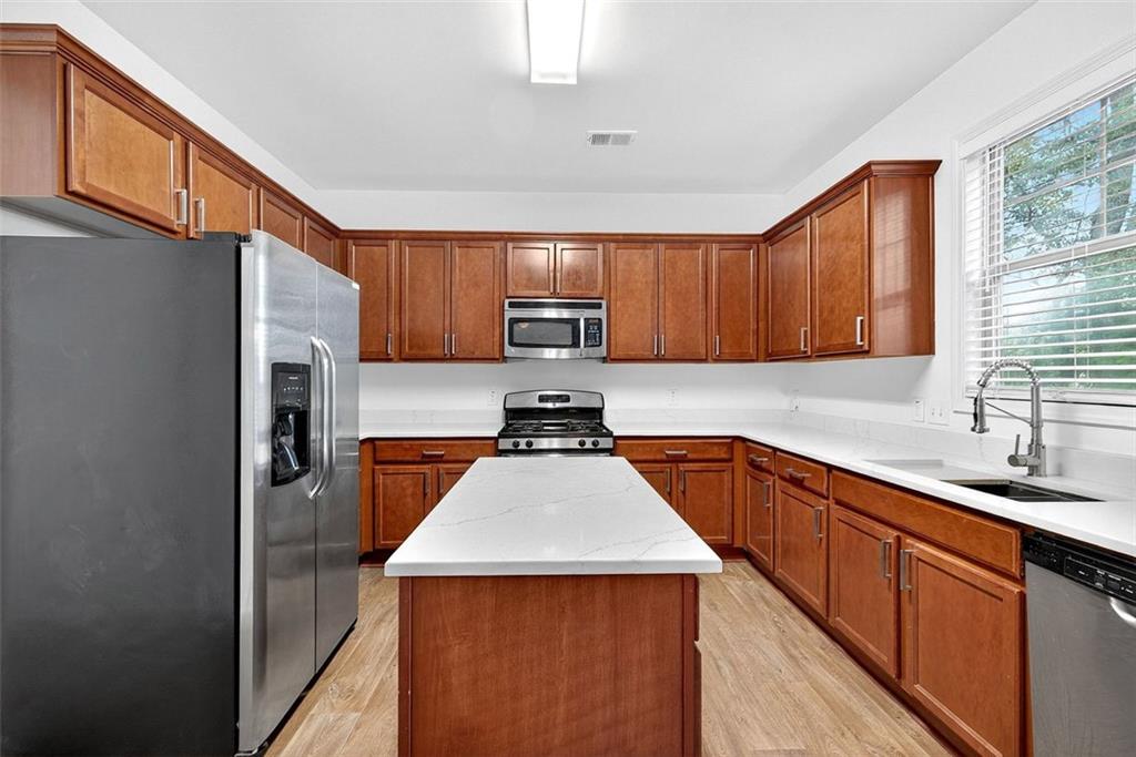 2517 Kolb Manor Circle Southwest Marietta, GA 30008 - Photo 7 of 33 a kitchen with granite countertop a sink stove and refrigerator
