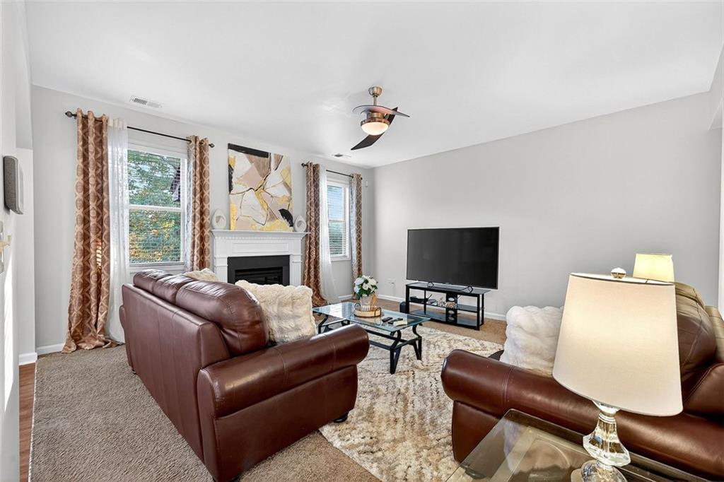2517 Kolb Manor Circle Southwest Marietta, GA 30008 - Photo 9 of 33 a living room with furniture fireplace and a flat screen tv