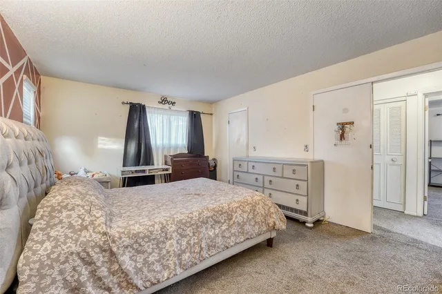 a bedroom with a bed and cabinets