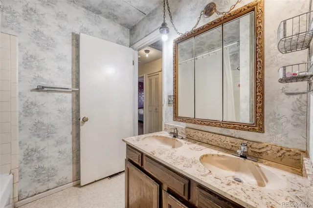 a bathroom with a granite countertop sink and a mirror