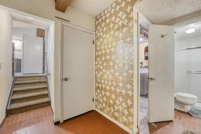 a view of a bathroom with white walls and shower