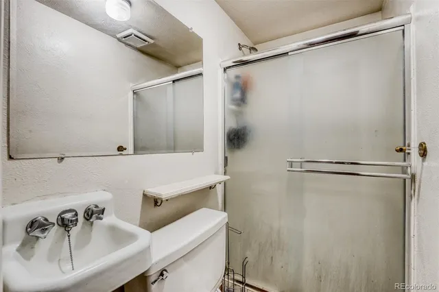 a bathroom with a sink and shower