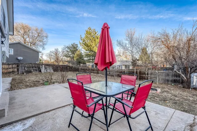 a view of a backyard with table and chairs