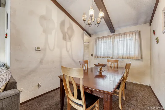 a view of a dining room with furniture and chandelier