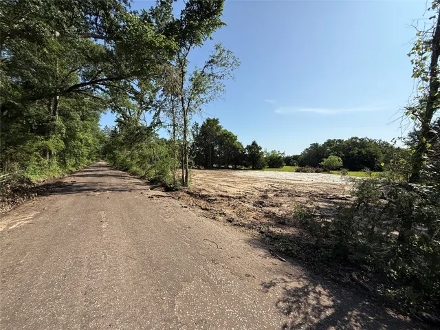 a view of a road with a yard