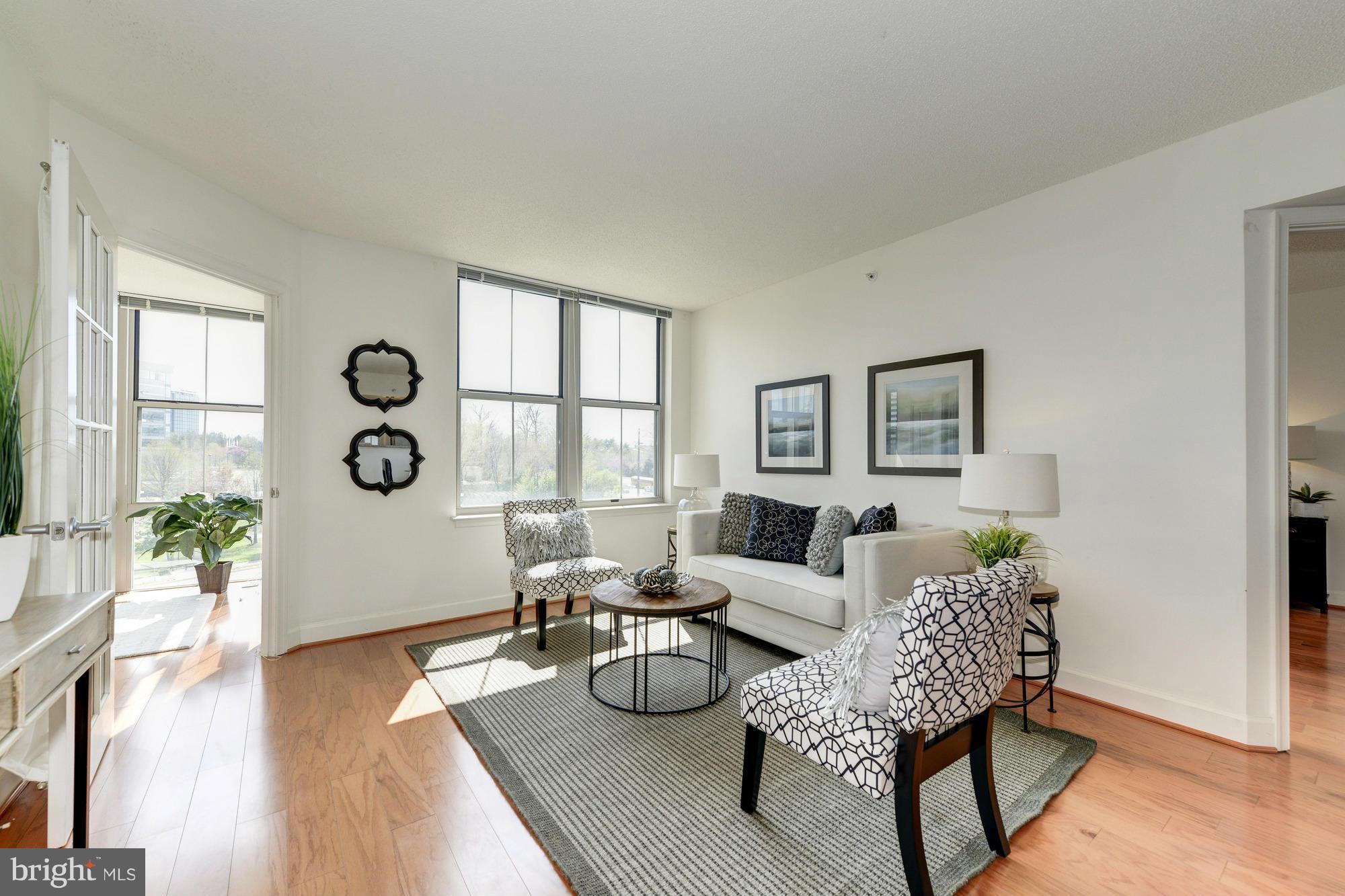 11800 Sunset Hills Road, Unit 517 Reston, VA 20190 - Photo 1 of 29 a living room with furniture and wooden floor