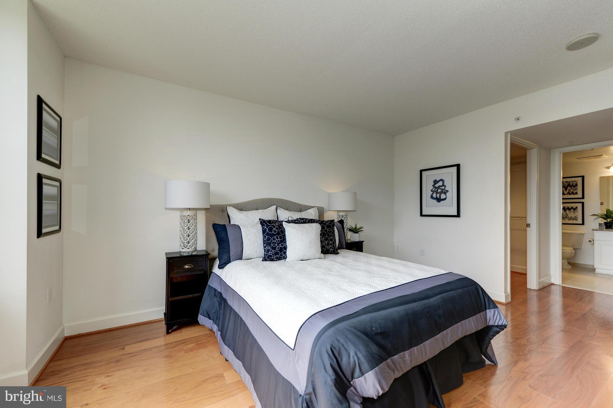 11800 Sunset Hills Road, Unit 517 Reston, VA 20190 - Photo 11 of 29 a bedroom with a bed and wooden floor
