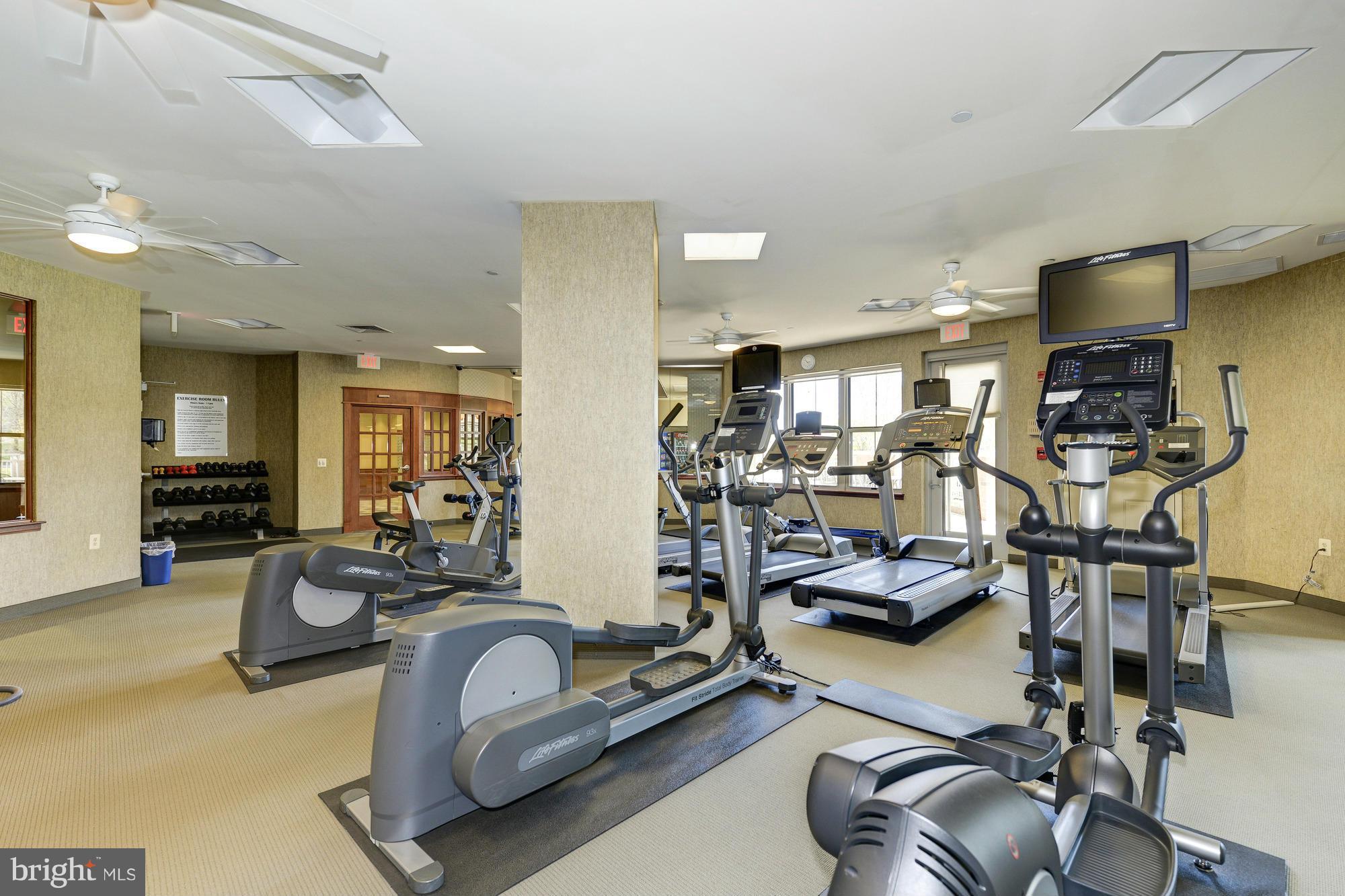 11800 Sunset Hills Road, Unit 517 Reston, VA 20190 - Photo 20 of 29 a room with gym equipment and a flat screen tv