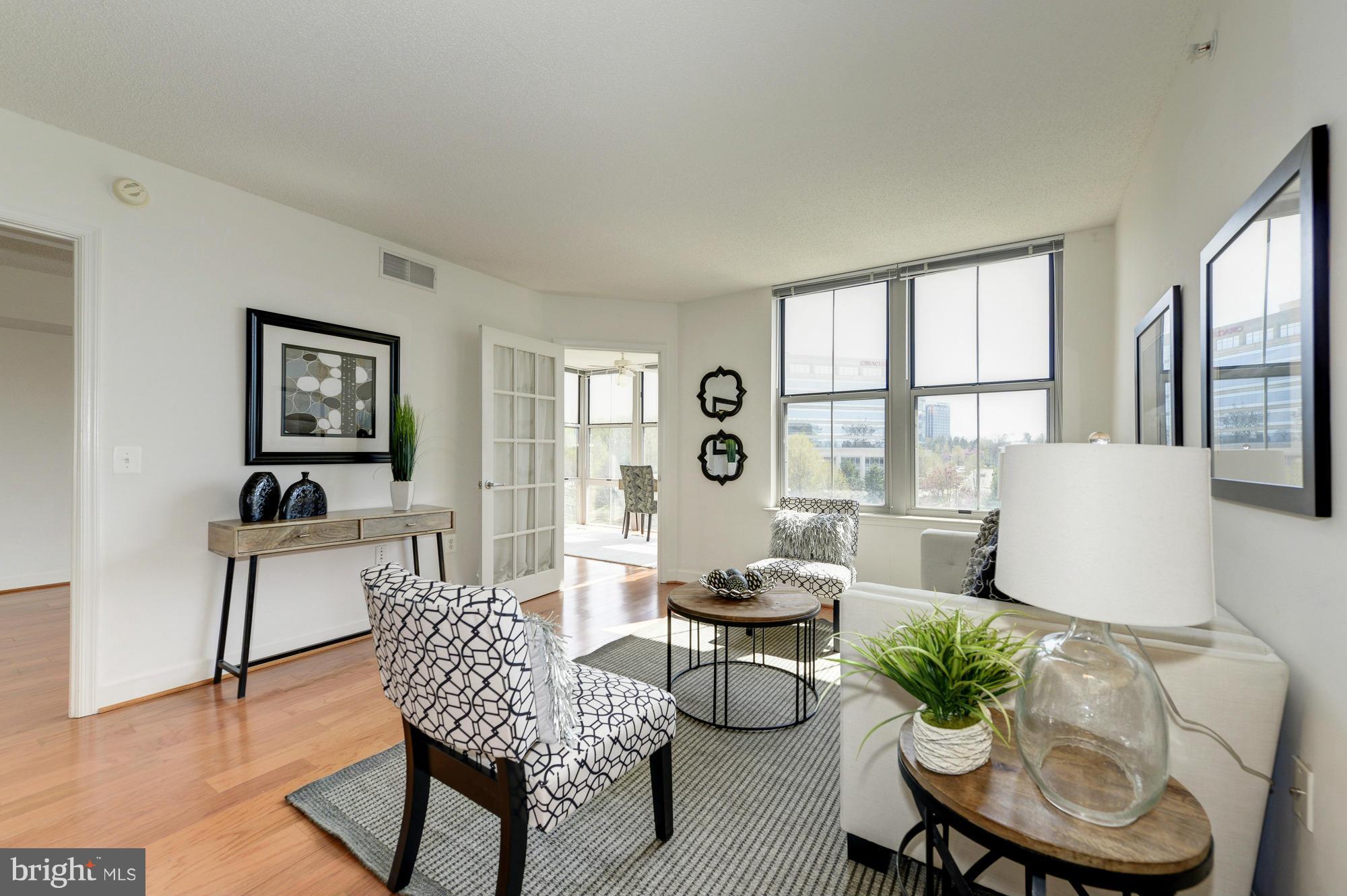 11800 Sunset Hills Road, Unit 517 Reston, VA 20190 - Photo 3 of 29 a living room with furniture and a large window