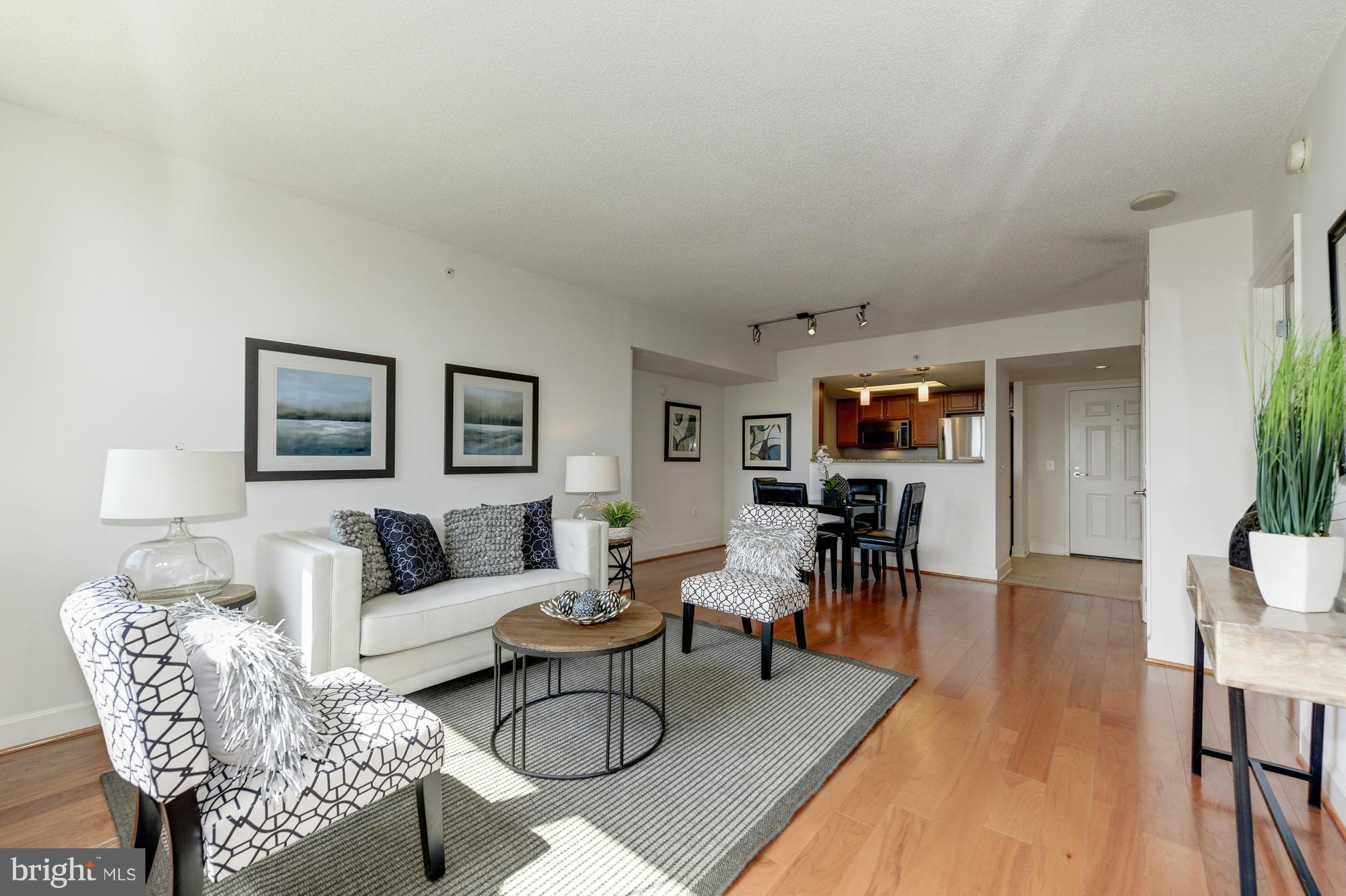 11800 Sunset Hills Road, Unit 517 Reston, VA 20190 - Photo 4 of 29 a living room with furniture and a wooden floor