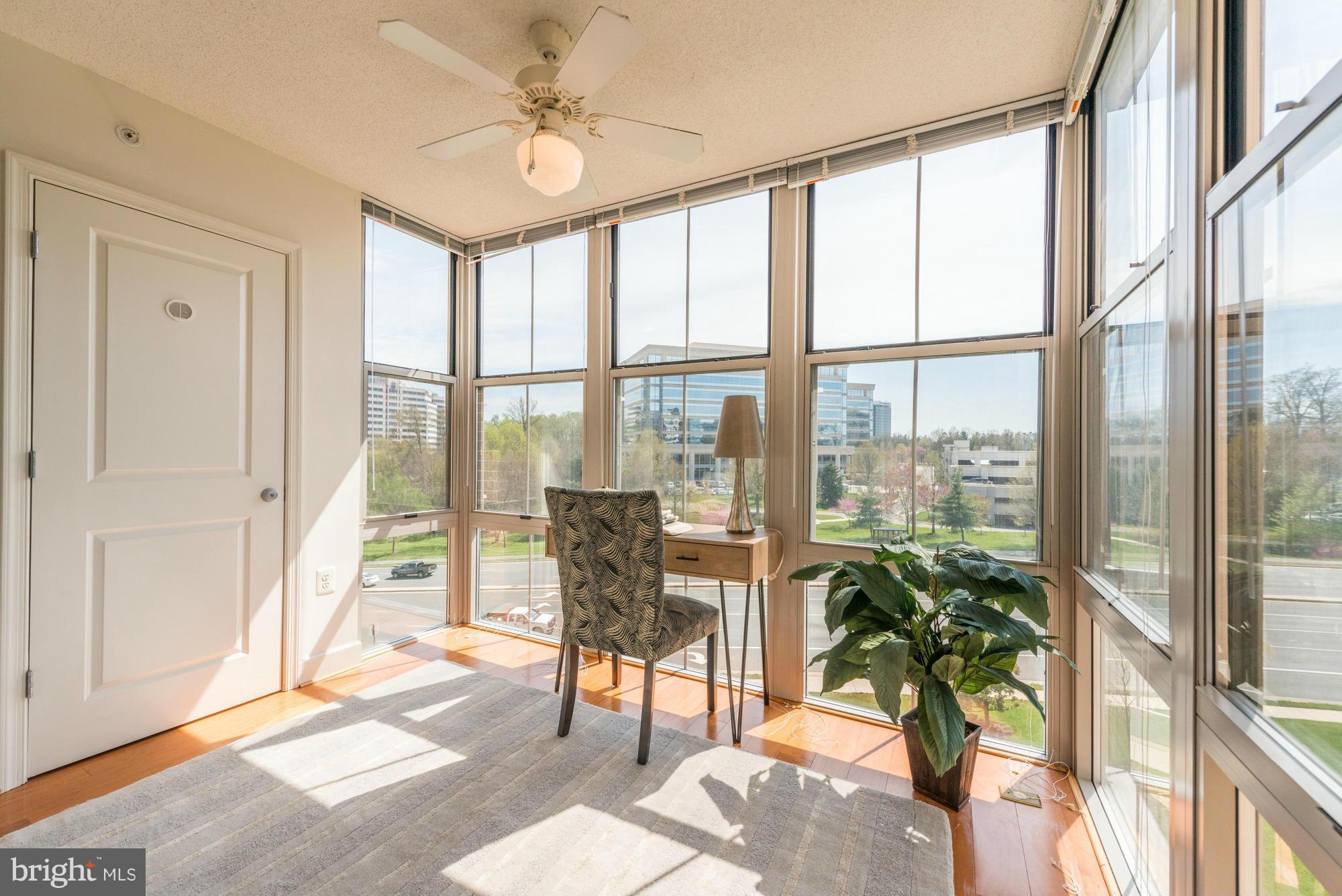 11800 Sunset Hills Road, Unit 517 Reston, VA 20190 - Photo 5 of 29 a view of a livingroom with furniture and floor to ceiling window