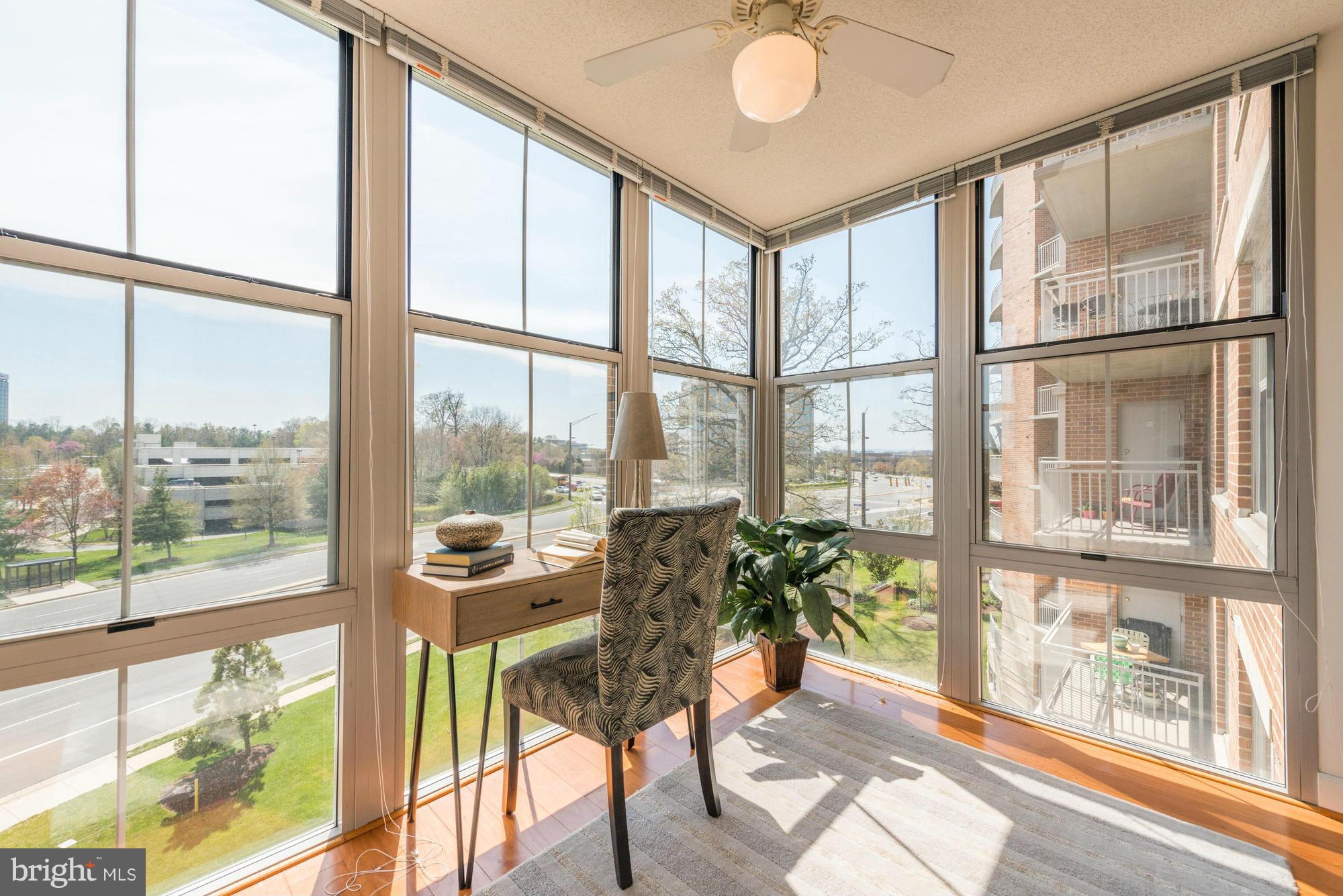 11800 Sunset Hills Road, Unit 517 Reston, VA 20190 - Photo 6 of 29 a room with furniture and a large window with wooden floor