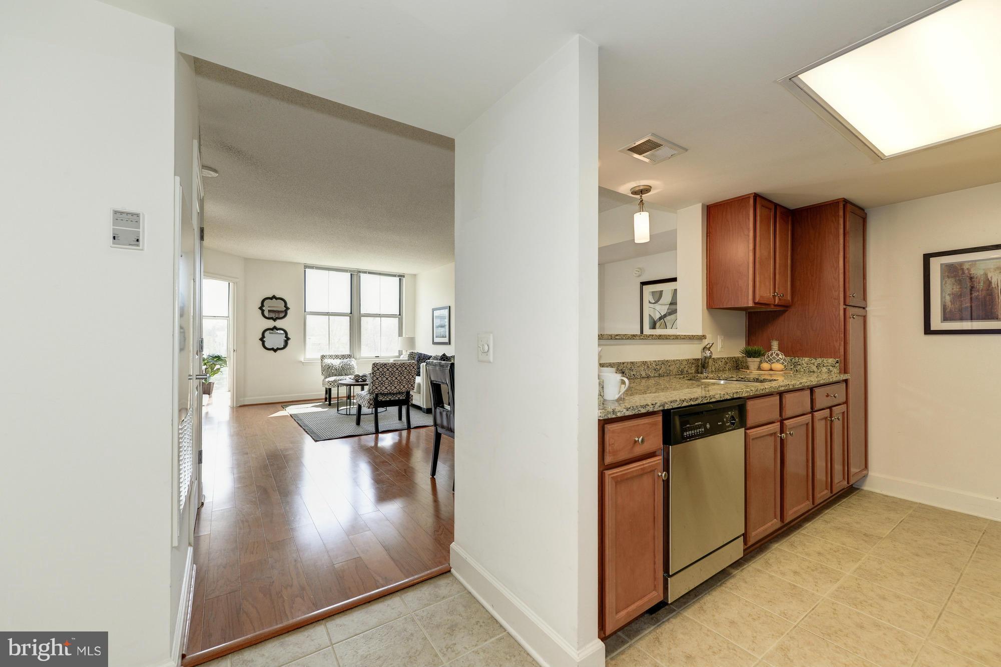 11800 Sunset Hills Road, Unit 517 Reston, VA 20190 - Photo 8 of 29 a view of living room with granite countertop furniture and fireplace