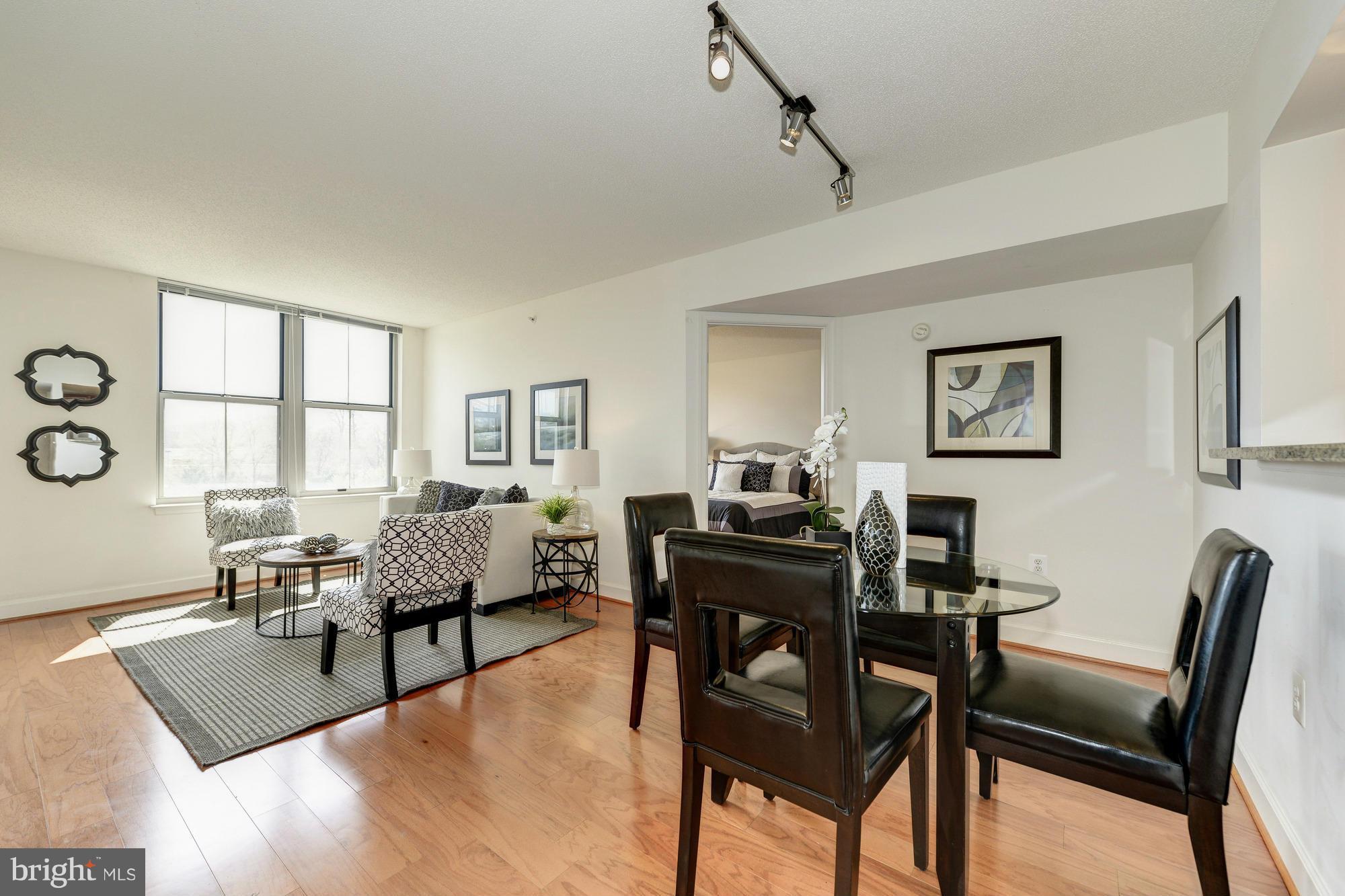 11800 Sunset Hills Road, Unit 517 Reston, VA 20190 - Photo 9 of 29 a living room with furniture and a window