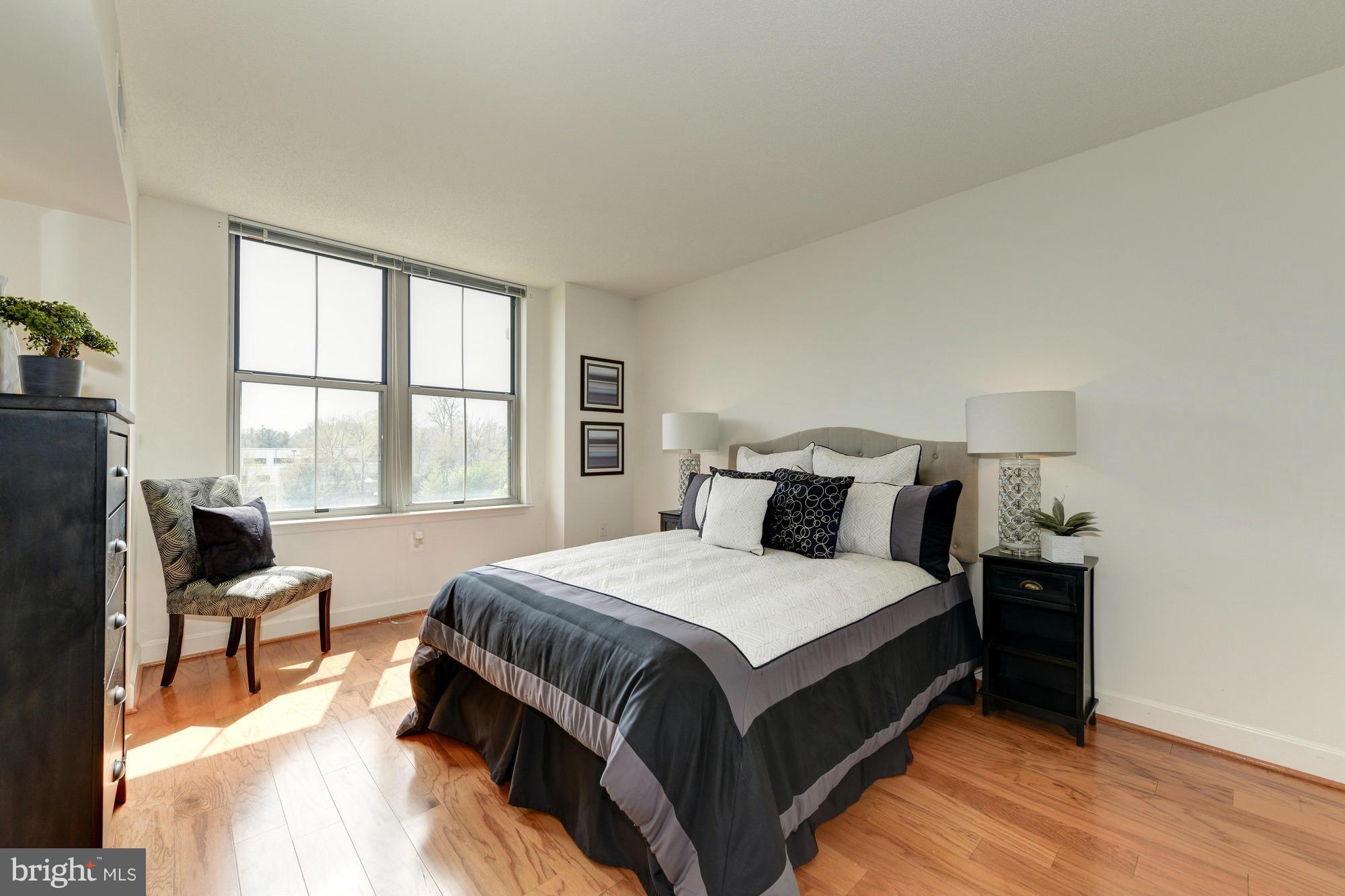 11800 Sunset Hills Road, Unit 517 Reston, VA 20190 - Photo 10 of 29 a large bed sitting in a bedroom next to a window
