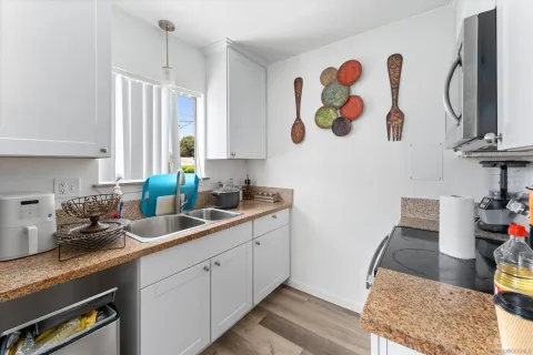 a kitchen with a sink cabinets and window