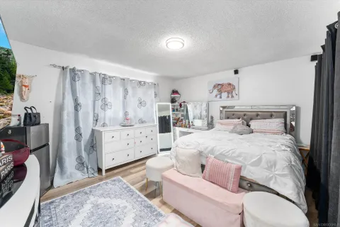 a spacious bedroom with a bed and a window