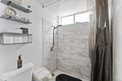 a bathroom with a shower and a sink