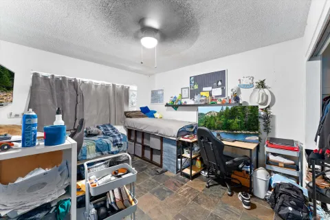 a room with furniture a rug toys and a flat screen tv